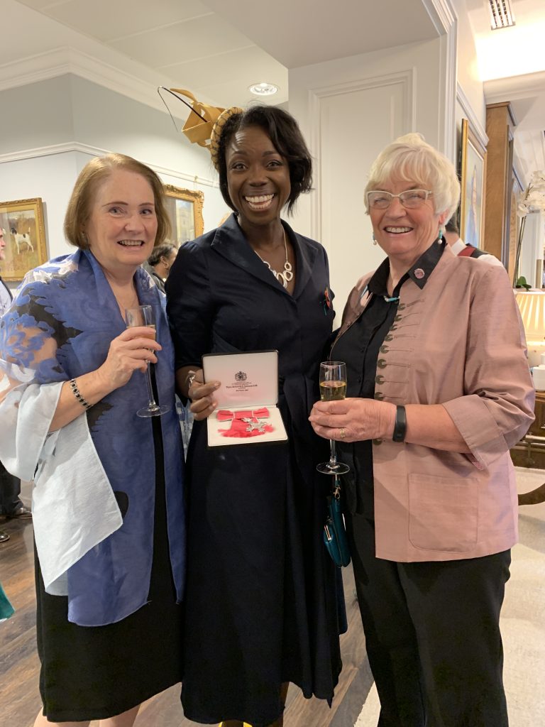 Barbara Bray shows her MBE medal to Chris Hawkins and Dr Margaret Ashwell 2019